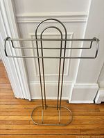 Full view of stainless steel freestanding towel rack showing overall design and structure