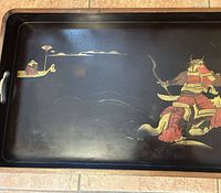 Top view of black lacquer tray showing full painted samurai and boat scene