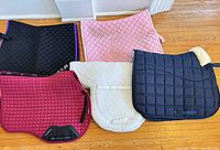 Group shot of five saddle pads laid out