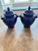 Front view of both blue ceramic ginger jars with lids