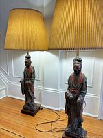 Two Quan Yin lamps with pleated shades side by side