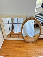 Both mirrors leaning against wall