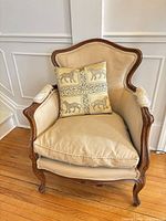 Front view of French Bergere armchair with tiger pillow