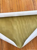 Wallpaper unrolled showing chartreuse silk texture