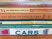 Stack of six automobile books showing spines and titles
