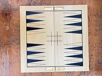 Folding board open showing backgammon triangles and tic-tac-toe grid