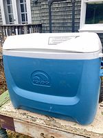 Front view of blue Igloo cooler with closed white lid
