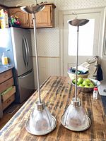 Both pendant lights showing size difference on table