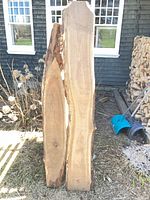 Front view of both live edge boards leaning upright outdoors
