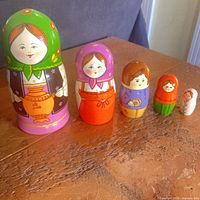 All five nesting dolls lined up by size