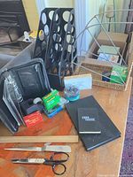 Overview of desktop organizers, folio, tools and small supplies on table