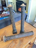 three fluted wooden legs on table