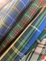 Stack of five tartan fabric pieces