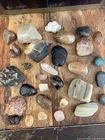 Group view of all assorted rocks and stones on wooden surface