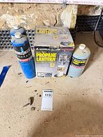 Boxed lantern with three propane canisters