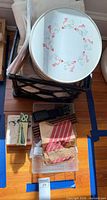 Overall lot showing boxed linoleum cutter, crate, tin lid, fabrics