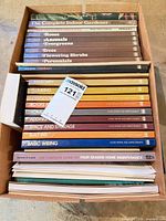 Box of colour-coded Time-Life Home Repair and Improvement books plus larger gardening guides