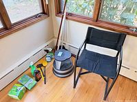 Overall view showing chair, step stool, broom, measuring rod, assorted cleaners