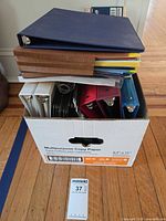 Box of assorted letter-size binders and folders