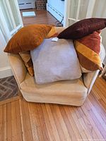 Chair front with pillows piled on seat