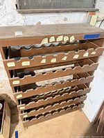 Full front view of brown MDF wine rack with multiple bottle slots