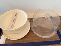 Group view of ceramic pie dish, ceramic plate, acrylic stand, plastic dome