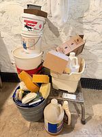 Overall lot showing stacked buckets, metal pail, sponges, chemical jugs and boxes