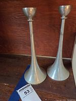 pair of metal candlesticks, frontal view