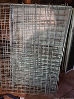 stacked galvanized wire panels with metal tray behind