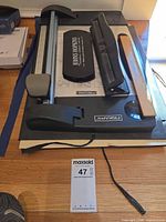 Top view of Fiskars rotary paper trimmer with hole punch, ruler and sticky notes visible