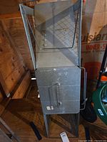 Full view of galvanized steel live trap standing upright