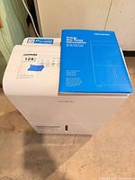 Front and top view showing control panel, brand label, manual