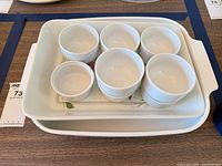 Top view showing both baking dishes and seven ramekins stacked