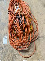 Overall view of cords showing orange loose coil covering packaged cords