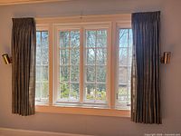 Large window with two blue-gray subtle-stripe pinch pleat panels