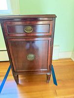 Front view of mahogany veneer nightstand showing drawer and cabinet door closed