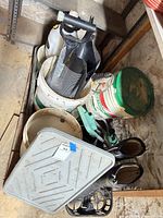 Overall view showing boots, buckets, sprayer, trays and tools stacked together