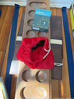 Wooden mancala board, Mensa puzzle box, red marble bag on closed backgammon case