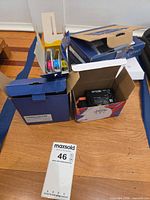Overview of Brother and Epson cartridge boxes, some opened to show contents