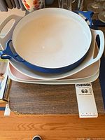 Stack showing blue enameled casserole over three ceramic platters