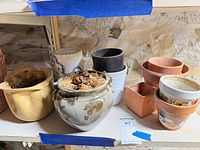 Assorted planters on shelf