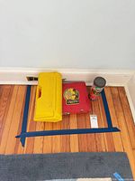 Yellow Gabriel Erector case, red Erector metal case, Tinkertoy tube grouped