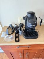 Mr. Coffee espresso machine with accessories arranged on countertop