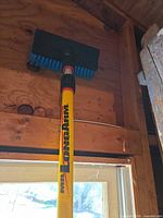 Pole extended upright showing brush head and Mr. LongArm logo