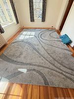 Full view of the grey geometric shag rug laid out in room