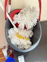 Bucket interior showing mop heads and wringer