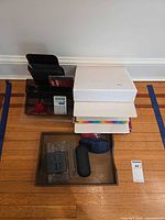 Lot overview showing binders, acrylic organizer, calculator, wooden tray with accessories
