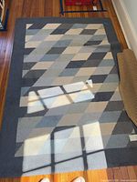 Full view of rug showing geometric pattern and colors