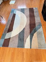 Full view of modern geometric rug on hardwood floor