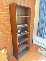 Front angled view of full-height bookcase showing shelves and finish